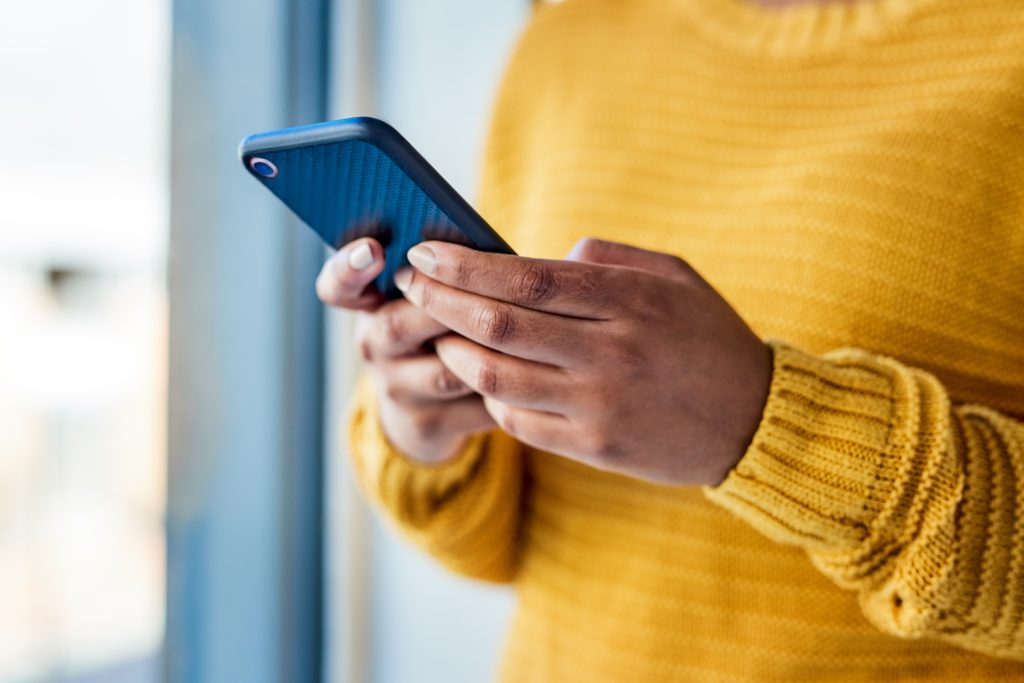 Close up of a clutched mobile phone.