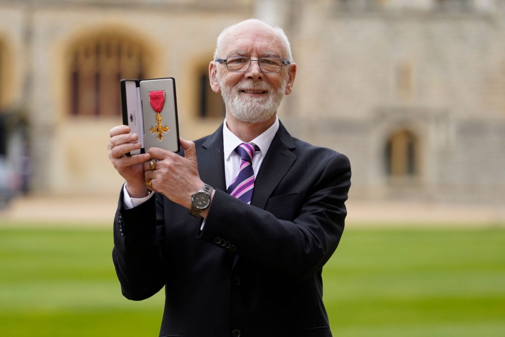Martyn Butler OBE holds his OBE.